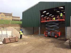 Engineers installing a new shutter for a warehouse
